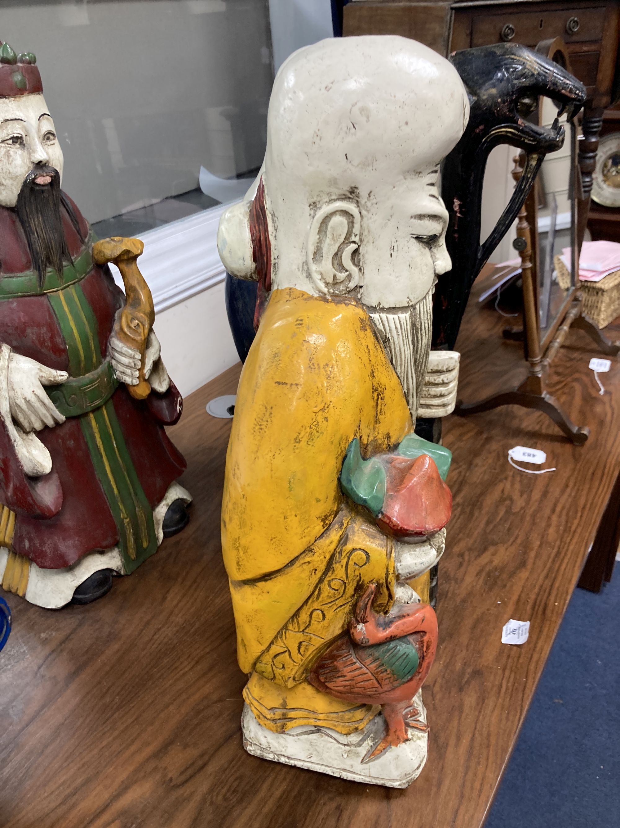 A trio of polychrome painted carved Chinese hardwood figures, tallest 67cm